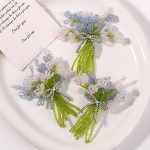 Three handmade beaded lavender and tulip flower brooches with blue and green bead accents