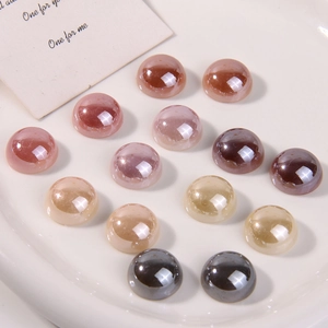 Detailed view of colorful polished half-round faux pearl beads for DIY craft projects