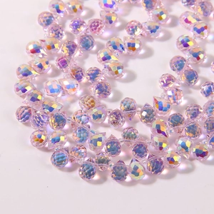 Macro view of purple faceted teardrop glass beads with AB iridescent rainbow finish