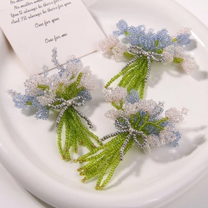 Three handmade beaded lavender tulip bouquets in a white ceramic tray with a card