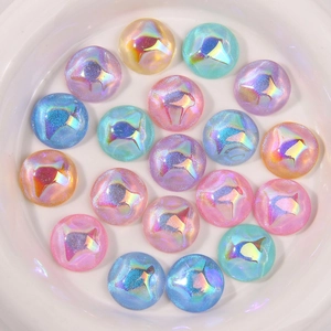 Close-up of iridescent rainbow glitter cabochons for DIY crafts in a white ceramic dish
