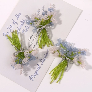 Detailed handcrafted beaded lavender brooch with a silver bow on vintage background