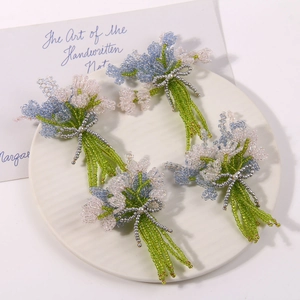 Handmade beaded lavender and tulip bouquets in blue and white with silver bow detail