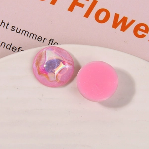 Macro shot of circular pink resin charms with laser ripple and glitter effects for DIY crafts