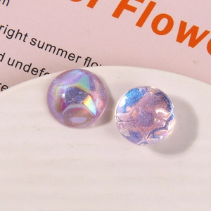 Macro shot of circular dreamy starry glitter charms with purple and blue gradient effect