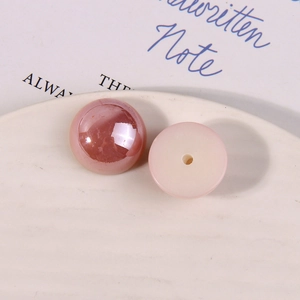 Macro detail of pink round acrylic faux pearl beads with hole for DIY jewelry making