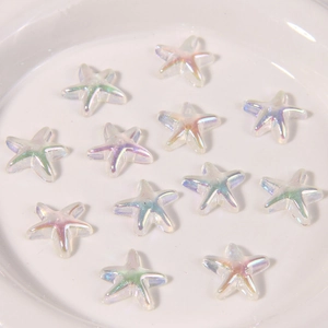 Close-up of iridescent star-shaped resin charms with dreamlike AB aurora coating