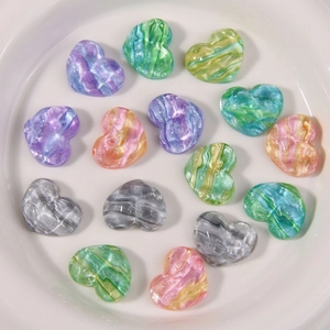 Macro view of colorful heart resin charms with water ripple texture and pearlescent finish
