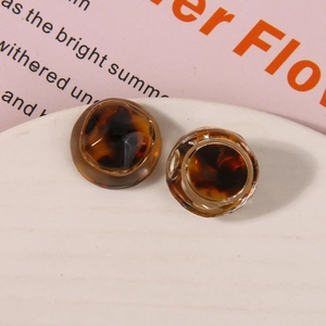 Macro view of vintage tortoiseshell resin charms with brown amber woven texture