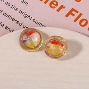Macro shot of circular resin shoe charms with vintage woven texture and gold metal frame