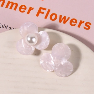 Close-up of pink marble texture acetate flower hair accessory with white pearl center