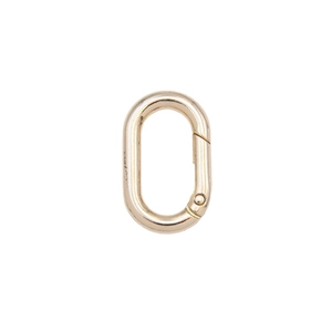 Polished gold oval spring snap carabiner for bags and keychains on white background