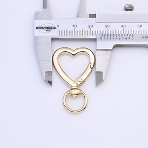 Macro detail of gold-plated heart-shaped swivel lobster clasp measuring 25mm in width