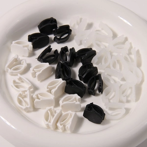 Macro detail of black and white plastic adjustment buckles for DIY footwear accessories