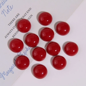 Close-up of glossy dark red 21mm resin cabochons for DIY earring and jewelry making