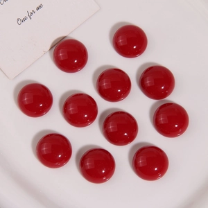 Detail view of 21mm round dark red resin cabochons for DIY earring and jewelry making