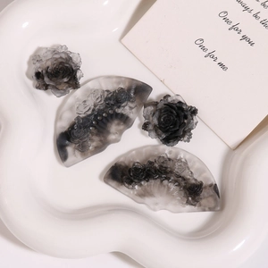 Detailed set of four DIY resin accessories with smoky black floral and fan-shaped ink patterns