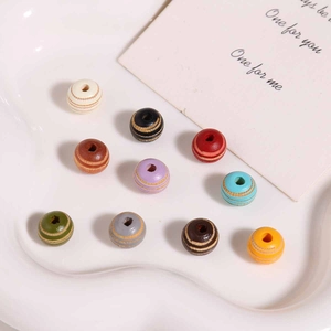 Macro shot of 10mm colorful wood beads with striped engraving for DIY craft jewelry