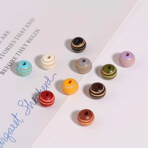 Close-up of 10mm colorful striped wooden beads for DIY jewelry and crafts