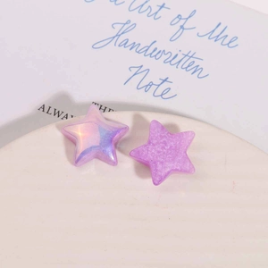 Macro detail of purple pearlescent resin star charms for DIY jewelry and hair accessories