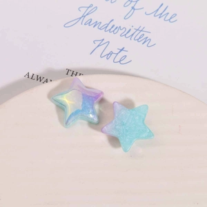 Macro view of gradient star resin charms with iridescent finish for jewelry DIY