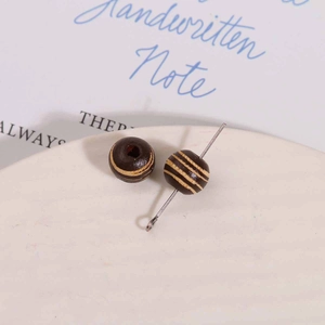 Macro detail of 10mm vintage striped wooden beads for DIY jewelry making and crafts