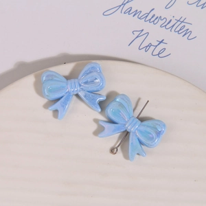 Détail d'un nœud bleu clair irisé avec support métallique pour création de bijoux DIY