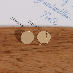 Macro shot of gold-plated flat ear stud bases with hanging loop for DIY jewelry making