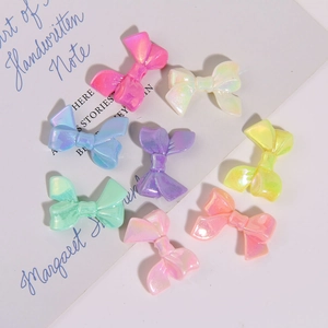 Macro shot of colorful pearlescent resin bow pendants for DIY jewelry and hair accessories