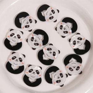 Panda-shaped acrylic charms for DIY earrings and hair accessories in a ceramic bowl