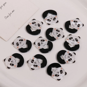 Macro shot of cute black and white panda acrylic beads with pearlescent glitter finish