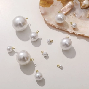 Multiple sizes of white pearl charms with gold loops for DIY jewelry making accessories