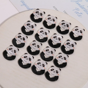 Cute panda acrylic pendants for DIY jewelry making neatly displayed on a tray