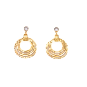 Macro shot of gold layered hoop earrings with textured finish and clear round gemstones