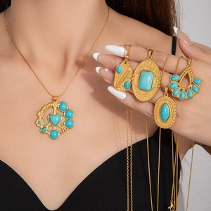 Close-up of bohemian gold layered necklaces with turquoise pendants on a model