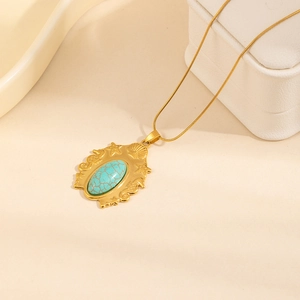 Bohemian gold-plated necklace featuring oval turquoise pendant with starfish and shell relief