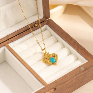 Detailed macro view of vintage flower pendant necklace with turquoise stone in a gift box
