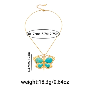 Detail of vintage gold butterfly pendant with turquoise stones and dimensions info