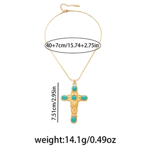 Detailed size parameters of the gold cross necklace with green stones and scrollwork