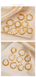 Detailed set of assorted gold plated hoop earrings with diverse textures on silk fabric
