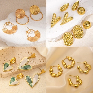 Detail showcase of various gold-plated stainless steel earrings with shell inlay and texture
