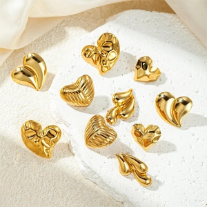 Detailed view of assorted heart-shaped gold plated earrings with textured finishes