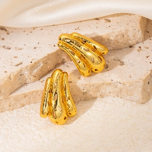 Detailed close-up of gold geometric earrings with organic coral texture and hollow design
