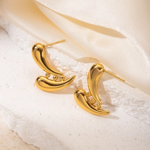 Detail view of 18K gold plated geometric earrings on elegant stone and silk