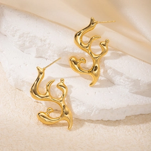 Macro detail of irregular liquid metal gold earrings on stone and silk background
