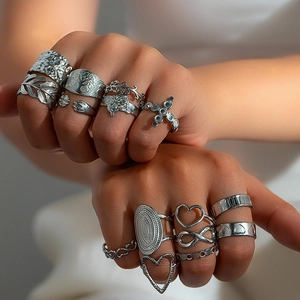 Macro shot of vintage silver rings set with hollow leaf and butterfly designs on hand
