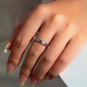 Detailed close-up of a silver geometric chain ring with solid and hollow circular links