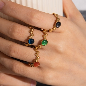 Detail of vintage 18K gold plated adjustable rings with colorful cat-eye gemstones