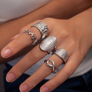 Detail of 5-piece vintage silver steel ring set with tree of life and infinity patterns