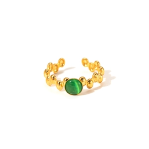 Detailed shot of an adjustable gold ring with green opal and beaded metal texture
